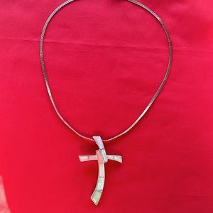 Silver cross pendant on silver necklace